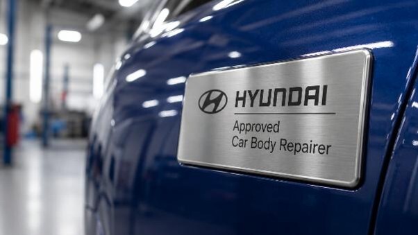 Hyundai approved repairer badge displayed on a vehicle at a professional accident repair centre.