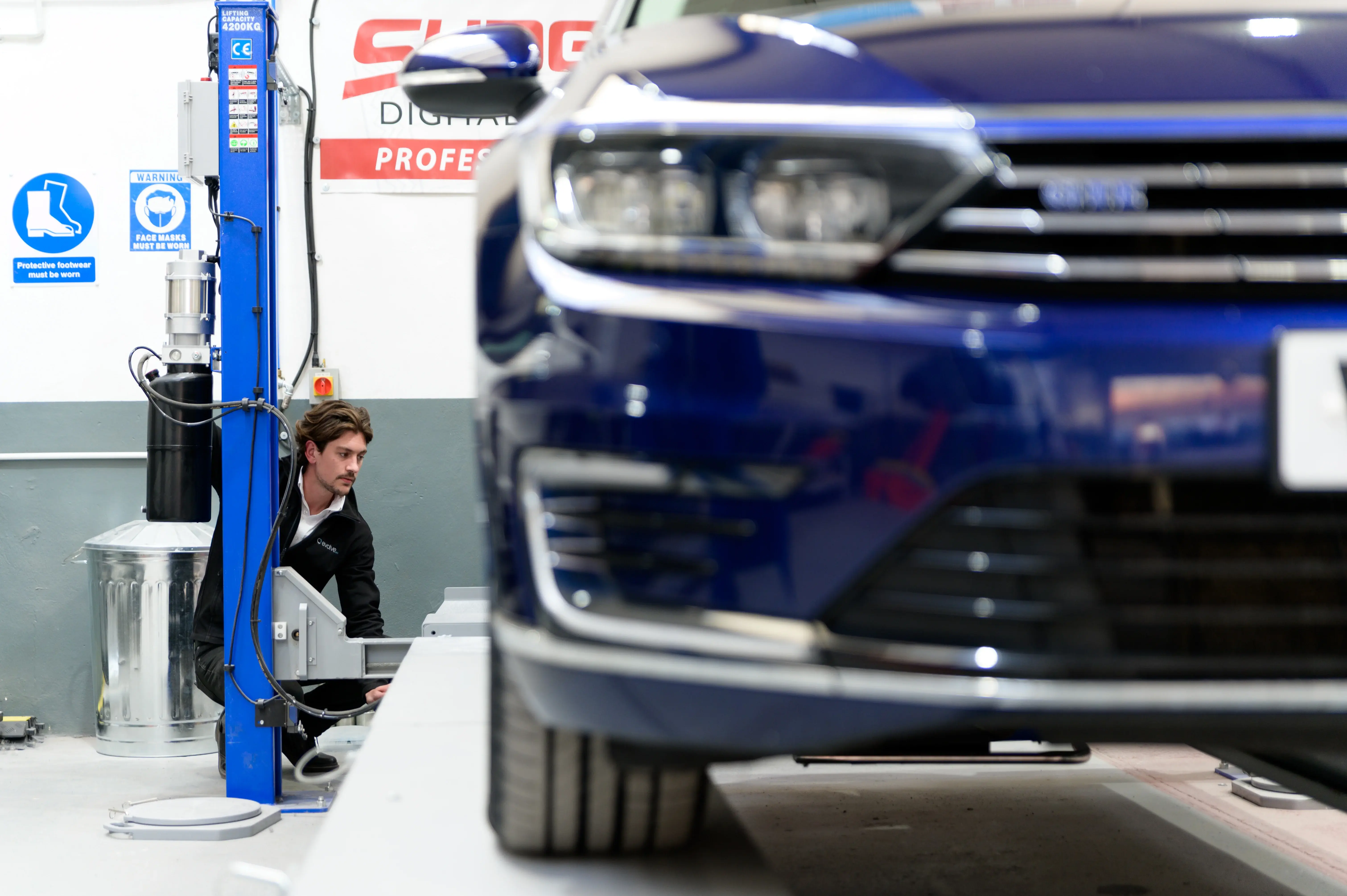 A mechanic at Evolve Arc starting an electric vehicle repair, which are different to standard petrol and diesel car repairs.